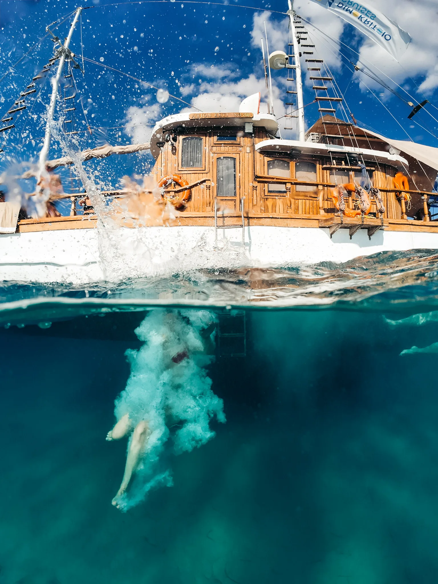 Guest swimming beside AXION ESTI during a private half-day cruise