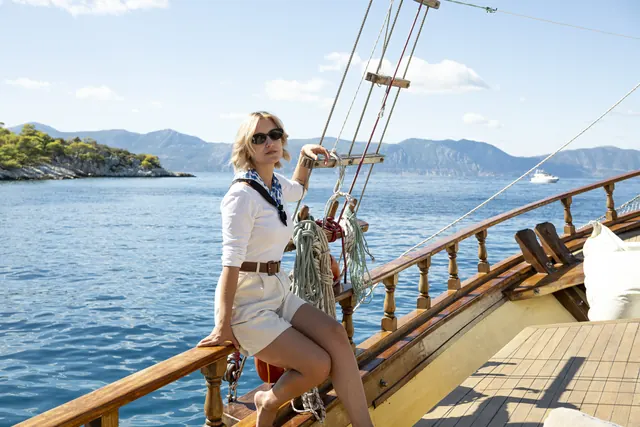 Guest seated by the yacht railing